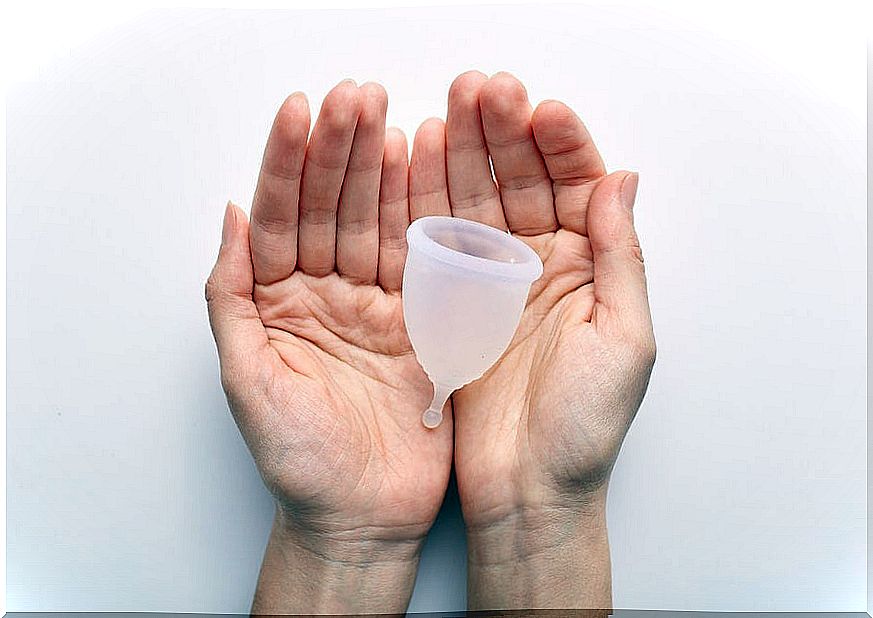 hands with a menstrual cup