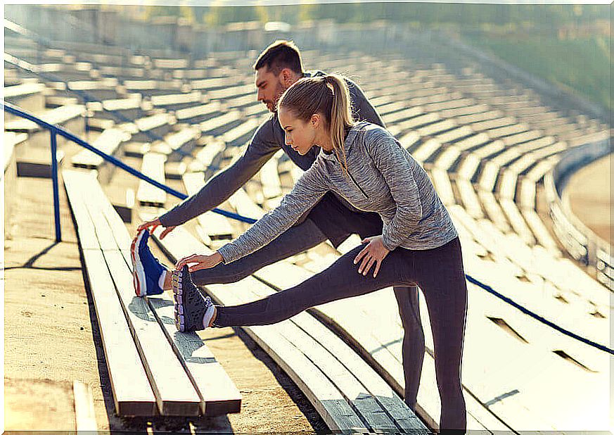 Couple stretching for a run.