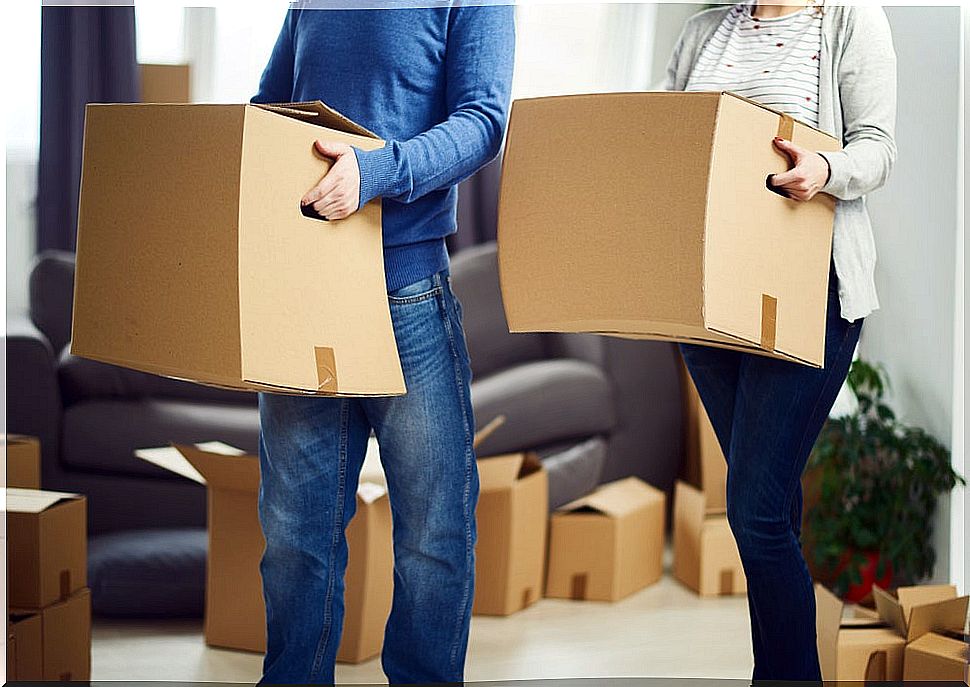 Man and woman carrying boxes.