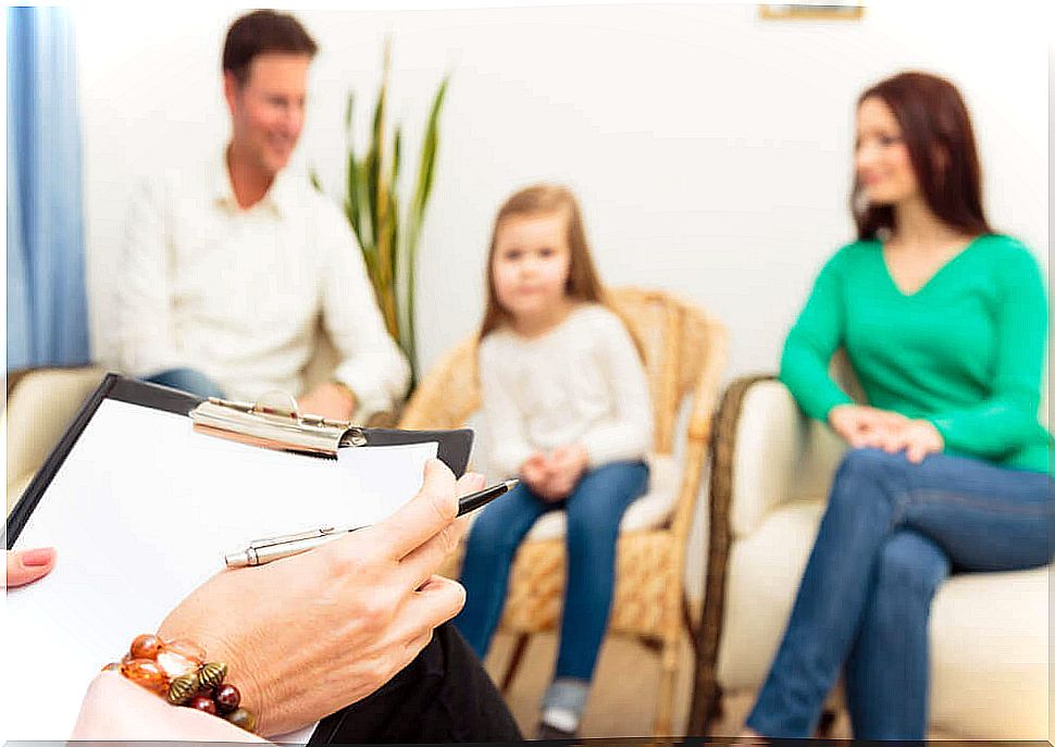 Parents sitting next to a little girl