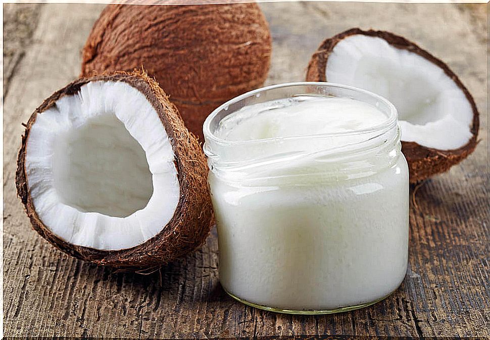 Coconut cream jar surrounded by halved coconuts