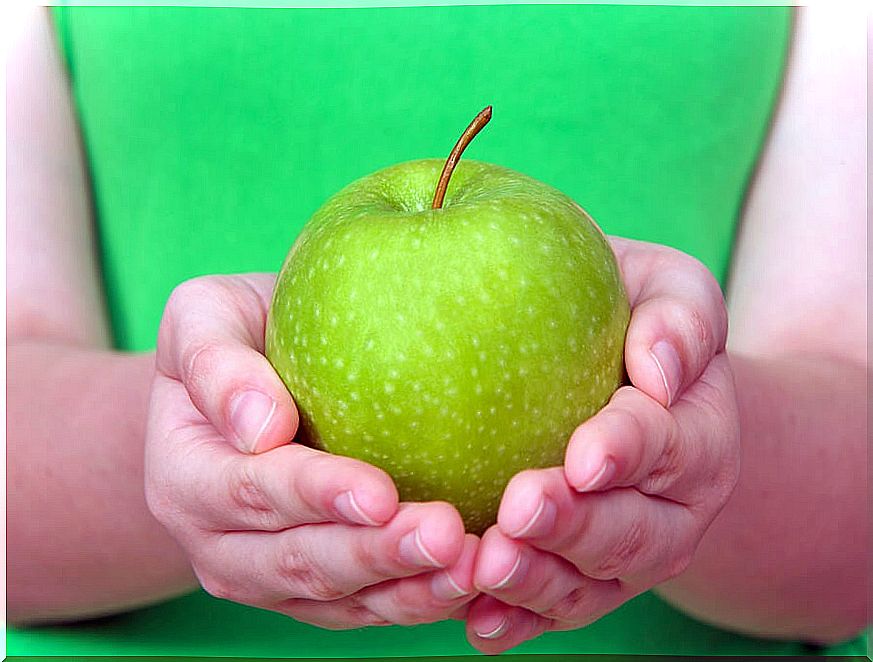 Woman's hands holding an apple