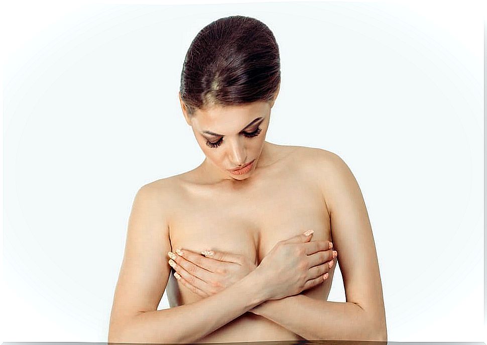 Woman covering her breasts