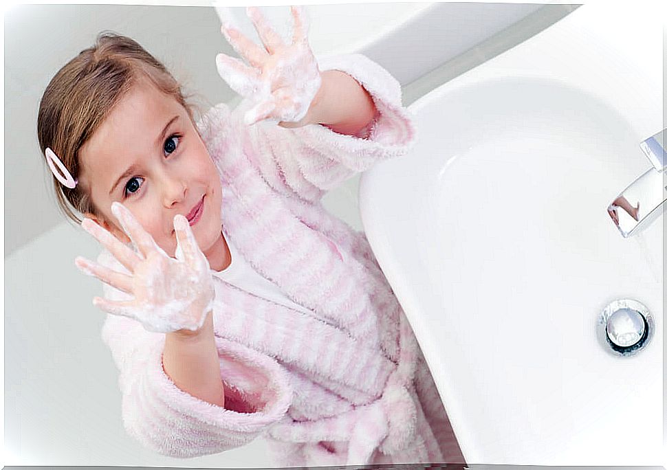 Girl washing her hands.