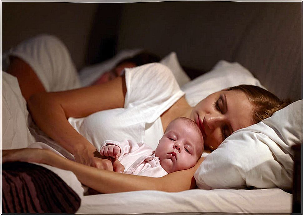 Baby sleeping with parents.